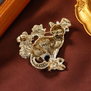 Vintage gold cat brooch with oil painting finish on textured brown fabric background