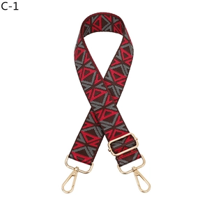 Close-up of ethnic geometric pattern webbing with light gold lobster claw buckles