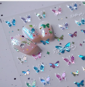 Macro shot of 3D iridescent butterfly nail stickers with laser effect and pearl accents