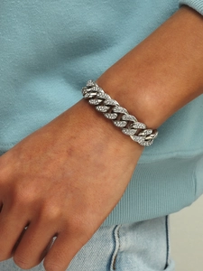 Men's silver Cuban link bracelet with sparkling rhinestones worn on a model's wrist