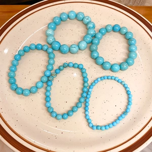 Detailed top view of turquoise bead stretch bracelets in five different bead sizes