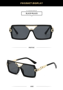 Detail view of square black sunglasses with golden hollow triangle bridge and chain temples