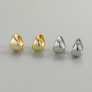 Detailed close-up showing polished gold and silver teardrop hoop earrings on grey background