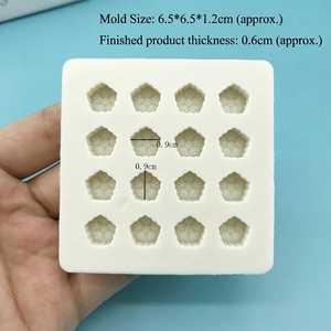 Mini cherry blossom silicone mold showing 16 cavities held in hand for size scale