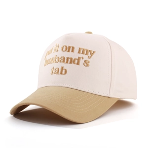 Detail of embroidered 'put it on my husband's tab' text on retro cotton baseball cap