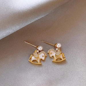 Gold plated rocking horse earrings with pearls and zircons on champagne silk