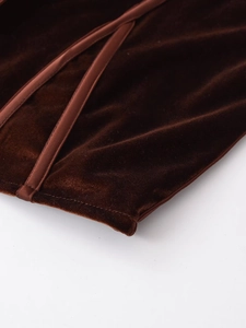 Macro view of chocolate velvet fabric texture with elegant satin trim detail