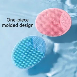 Pink and blue soft silicone baby scalp brushes for cleaning on light blue water background