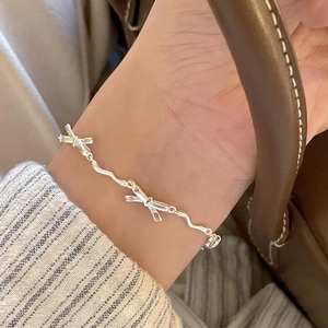 Elegant S925 sterling silver bow bracelet featuring a unique wavy chain for women