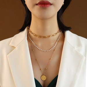 Three-layer titanium steel necklace with gold paperclip chain, pearls, and coin pendant
