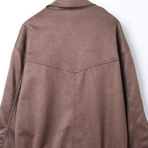 Macro detail of the brown suede jacket back with clear stitching and V-shaped seam design