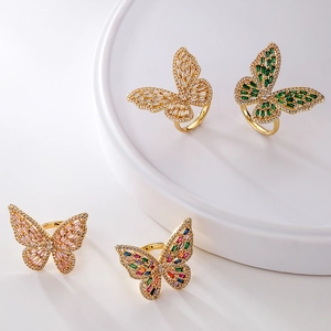 Elegant gold-plated butterfly rings with colorful cubic zirconia on minimalist display