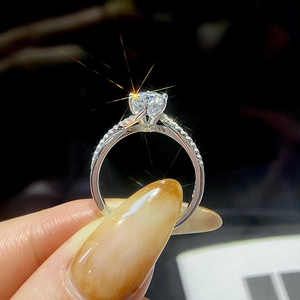 Classic six-prong round moissanite ring with twisted pavé band on model hand