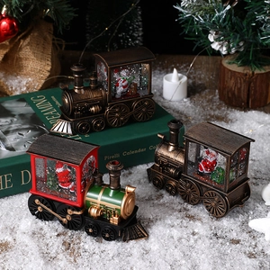 Detailed macro view of vintage Christmas train snow globes featuring Santa and snowman