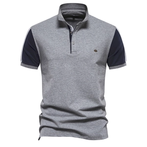 Detail of color-block polo shirt with grey body, navy sleeves and small chest logo