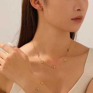 Detailed view of gold-plated celestial jewelry set with star and moon diamond pendants