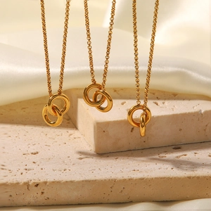 Interlocking double ring pendant necklace in gold finish on elegant silk background