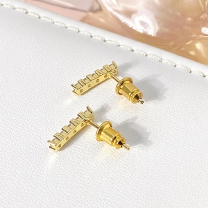 Minimalist gold bar stud earrings featuring rectangular pave cubic zirconia stones