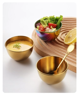 Detail showing golden and rainbow stainless steel sauce bowls with a vintage gold spoon