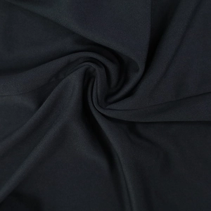 Close-up of the black textile fabric texture with fine woven detail and soft drapes