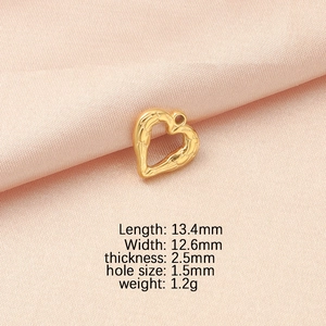 Macro detail of 13.4mm golden heart-shaped stainless steel charm with dimensions shown