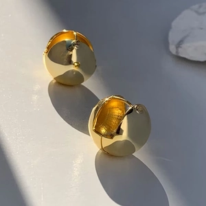 Minimalist polished gold ball huggie earrings with high-shine spherical design