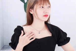 Silver heart pendant necklace on model showing delicate chain and minimalist fit