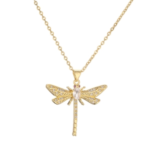 Detailed close-up of golden dragonfly pendant necklace with clear zircons and red eyes