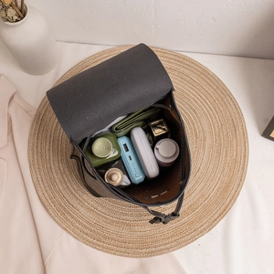 Black mini backpack with circle print showing spacious interior for phone and cosmetics