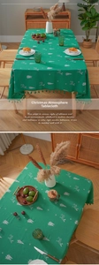 Detail of Christmas tablecloth with deer embroidery, green fabric and decorative tassels