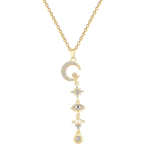Gold celestial tassel necklace with moon, star, evil eye charms and white cubic zirconia