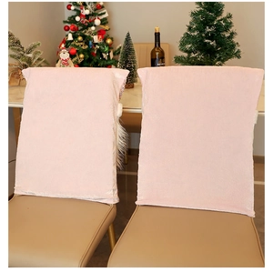 Pink velvet Santa chair covers in a festive Christmas dining room setting