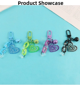Macro detail of heart-shaped glitter acrylic keychains with chains and bells