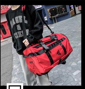 Dynamic outdoor street shot of a red large-capacity travel bag with adjustable strap