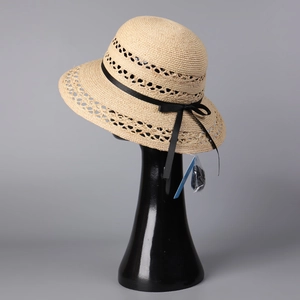 Women's natural raffia sun hat with hollow weave pattern and black ribbon bow detail