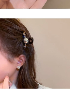 Close-up of pearl rhinestone hair clip and matching studs worn on model's side hair