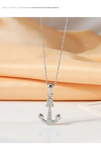 Macro shot of silver titanium steel anchor pendant with sparkling zircon insets