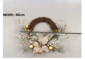 Detailed view of a 40cm Christmas wreath with gold flowers and snow-tipped pine needles