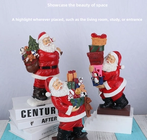 Detailed view of three resin Santa Claus figurines with Christmas trees and gift boxes