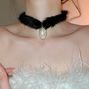 Detailed view of elegant black faux fur choker with a large water drop pearl pendant