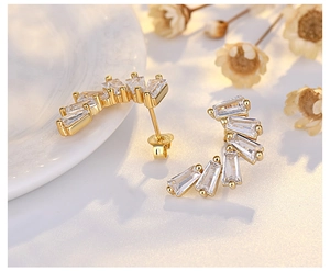 Macro shot of 925 silver crescent moon earrings with cubic zirconia and gold plating