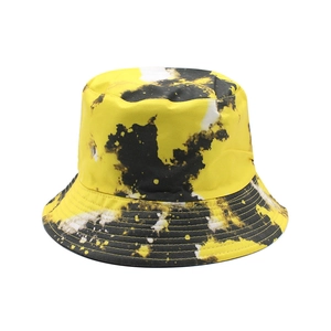Detail view of tie-dye bucket hat brim with yellow black pattern and multi-row stitching