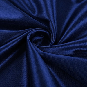 Detailed view of dark blue satin fabric with elegant drape and smooth texture