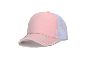 Close-up of pink distressed brim and white mesh on a vintage trucker cap for summer