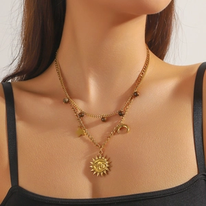 Gold layered necklace featuring vintage celestial sun moon and star charms with beads