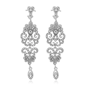 Vintage palace style long silver drop earrings with hollow diamonds on white background