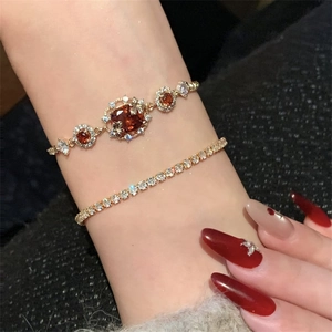 18K gold plated jewelry set with amber gemstones and clear crystals on a model wrist