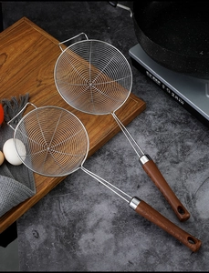 Kitchen setting with 304 stainless steel slotted spoons featuring wood grain handles