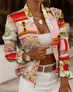 Detailed view of women's baroque print jacket with pink and gold patterns and metal zipper