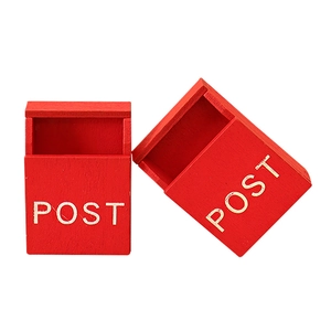 Miniature red wooden dollhouse mailboxes with white Post text on a white background